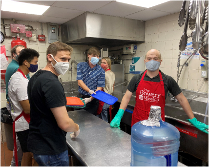 JFLCO team members volunteering in the kitchen during dinner service at The Bowery Mission.